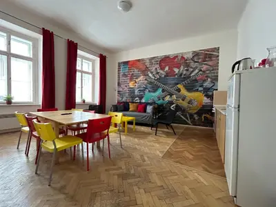 a kitchen and dining room with a table and chairs at PARTY HOUSE PRAGUE - Apartments Ve Smečkách 18, CITY CENTER!! in Prague