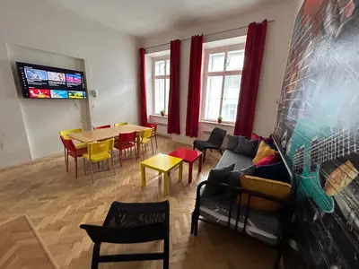 a living room with a couch and a table and chairs at PARTY HOUSE PRAGUE - Apartments Ve Smečkách 18, CITY CENTER!! in Prague