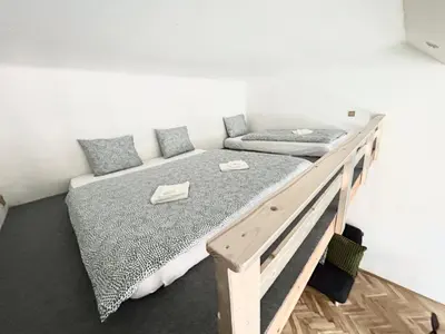 a bedroom with a large bed with a wooden frame at PARTY HOUSE PRAGUE - Apartments Ve Smečkách 18, CITY CENTER!! in Prague