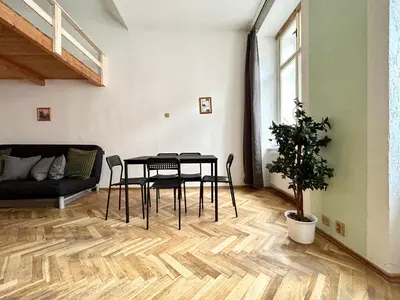 a living room with a table and a couch at PARTY HOUSE PRAGUE - Apartments Ve Smečkách 18, CITY CENTER!! in Prague