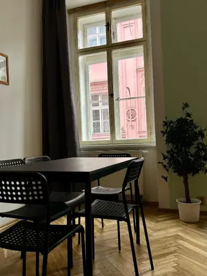 a table and chairs in a room with a window at PARTY HOUSE PRAGUE - Apartments Ve Smečkách 18, CITY CENTER!! in Prague