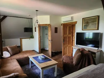 a living room with a couch and a table at Hospůdka Na Trucovně in Sázava