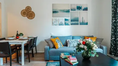 a living room with a blue couch and a table at Prague Retreat Apartment in Prague