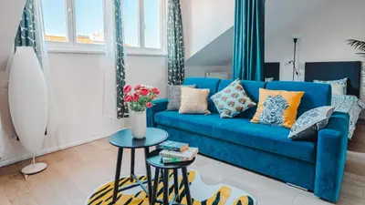 a blue couch in a living room with a table at Prague Retreat Apartment in Prague