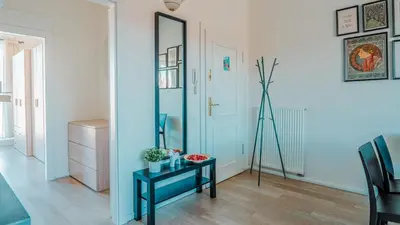 a room with a mirror and a table and a tripod at Prague Retreat Apartment in Prague