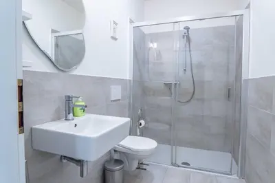 a bathroom with a shower and a toilet and a sink at Prague Retreat Apartment in Prague