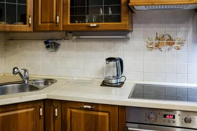 a kitchen with a wooden table and blue chairs at SMÍCHOV Riverfront Apartment Prague 5, Near Anděl in Prague