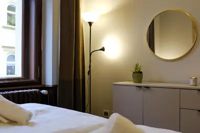 a hotel room with two beds and a night stand at SMÍCHOV Riverfront Apartment Prague 5, Near Anděl in Prague