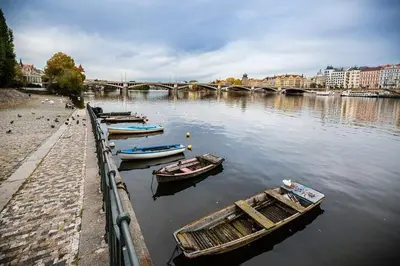 a row of cars parked on a street next to buildings at SMÍCHOV Riverfront Apartment Prague 5, Near Anděl in Prague