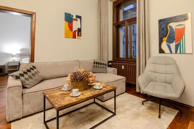 a living room with a couch and a chair at SMÍCHOV Riverfront Apartment Prague 5, Near Anděl in Prague
