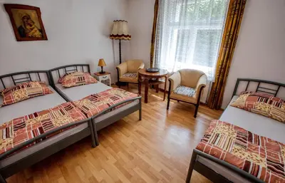 a bedroom with two beds and a table and chairs at Garden in the city in Prague