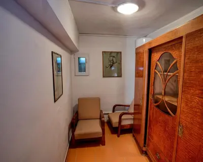 a hallway with a chair and a door at Garden in the city in Prague