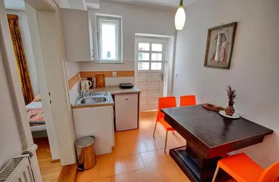 a kitchen and dining room with a table and orange chairs at Garden in the city in Prague