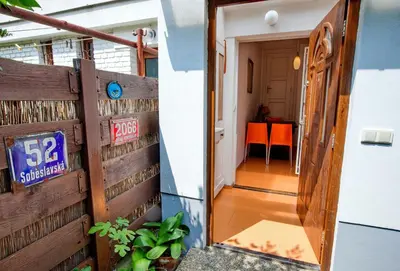 a door leading to a room with a table at Garden in the city in Prague