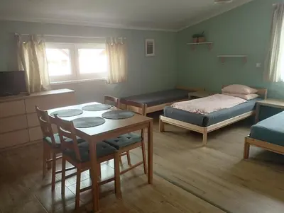 a bedroom with a bed and a table and chairs at Apartmány Audy 2 in Mníšek pod Brdy