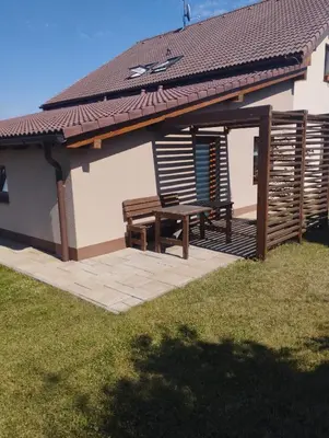 a patio with a picnic table and a roof at Apartmány Audy 2 in Mníšek pod Brdy