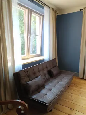 a couch in a living room with a window at Pod hradbami Křivoklát in Křivoklát