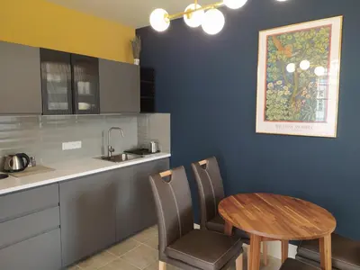 a kitchen with a wooden table and a table and chairs at Pod hradbami Křivoklát in Křivoklát