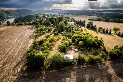 an aerial view of a farm with a field at Tiny house - Chatka v Řeži u Prahy in Husinec