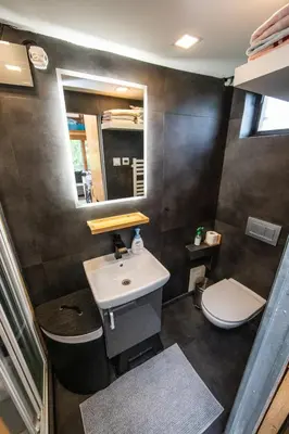 a bathroom with a sink and a toilet at Tiny house - Chatka v Řeži u Prahy in Husinec