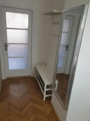 a dressing room with a mirror and a window at Newly refurbished central in Prague