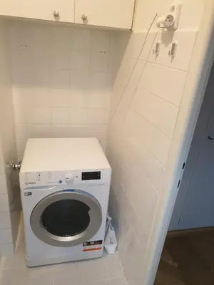a small bathroom with a washing machine in it at Newly refurbished central in Prague
