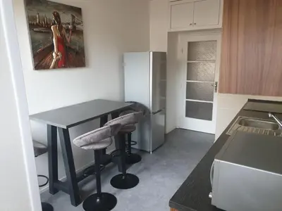 a kitchen with a black table and stools in it at Newly refurbished central in Prague