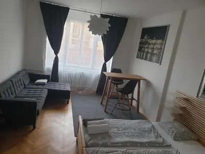 a living room with a couch and a table at Newly refurbished central in Prague