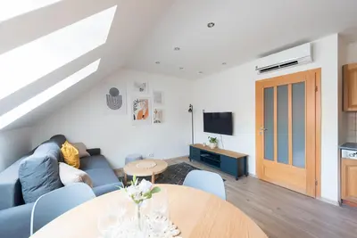 a living room with a blue couch and a table at B.O.B. Klimentská in Prague