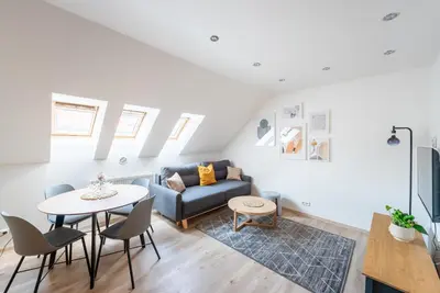 a living room with a couch and a table at B.O.B. Klimentská in Prague
