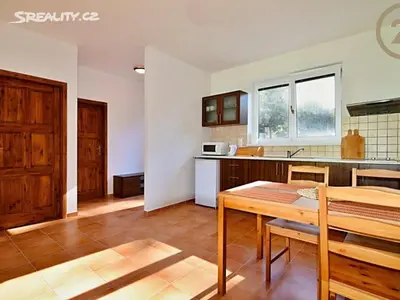 a kitchen with a table and a dining room at Apartmán Slapy, slapská přehrada - Nová Živohošť in Křečovice