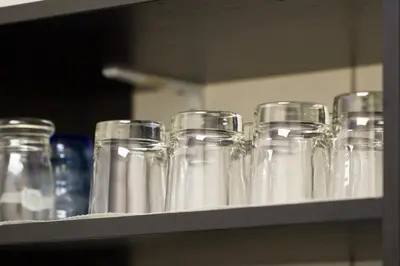 a shelf with clear glass containers on it at Hostel Seven in Prague