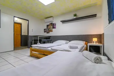 a bedroom with four beds in a room at Hostel Seven in Prague