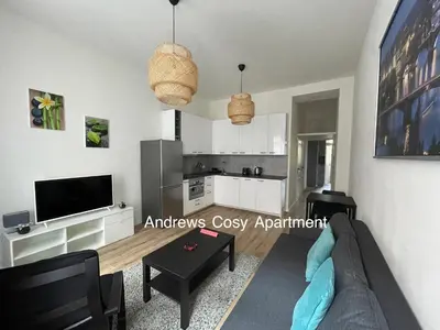 a living room with a couch and a tv at Andrews Cosy Apartment in Prague