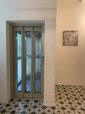 a glass door in a room with a tile floor at Andrews Cosy Apartment in Prague
