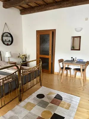 a living room with a bed and a table at Apartment DeLuxe in Prague