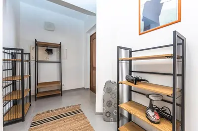 a room with wooden shelves and a room with white walls at Apartment DeLuxe in Prague