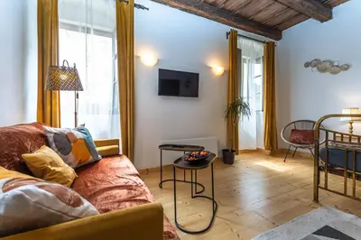 a living room with a couch and a table at Apartment DeLuxe in Prague
