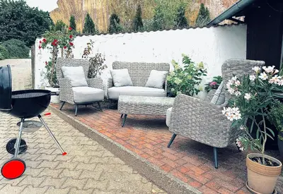 a patio with chairs and a couch and a grill at Penzion Arendel in Líšnice