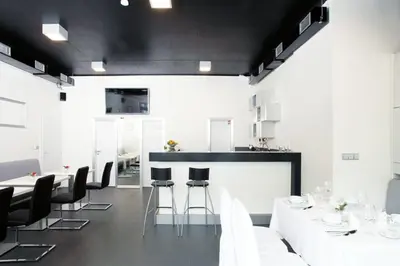a dining room with white tables and black chairs at Hotel U Karla in Prague