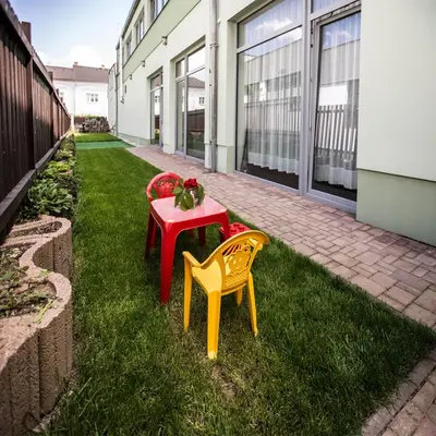 a table and chairs on the grass next to a building at Hotel U Karla in Prague