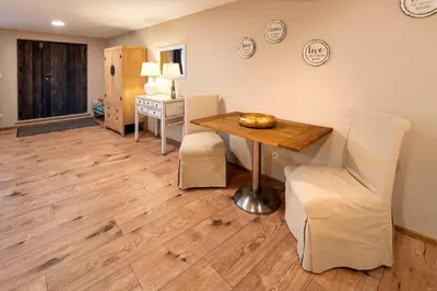a dining room with a wooden table and chairs at Prague West - Studio Chyne Terrace in Chýně