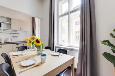 a kitchen with a table and a vase with a sunflower at Cool & Charming Apt in city center - lub5 in Prague