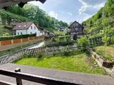 a view of a farm with a fence and houses at Chalupa Kruh in Doksy