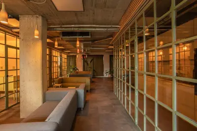 a row of couches in a room with windows at Cool place in Prague