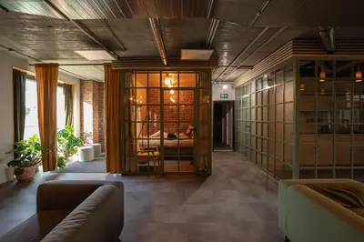 a living room with a couch and glass doors at Cool place in Prague