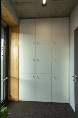 a wall of white cabinets in a room at Cool place in Prague
