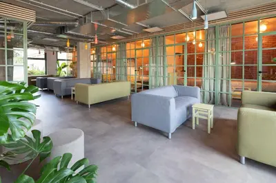 a waiting room with couches and tables and plants at Cool place in Prague