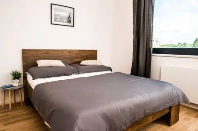 a large bed in a bedroom with a window at FREE PARKING- Newly built Apartment in Prague