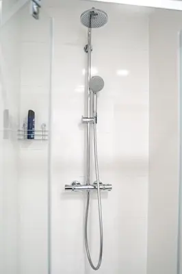 a shower with a shower head in a bathroom at FREE PARKING- Newly built Apartment in Prague